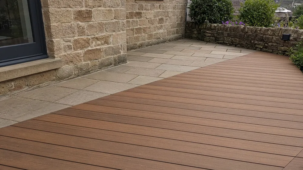 Example image: composite deck in a warm tone next to sandstone paving